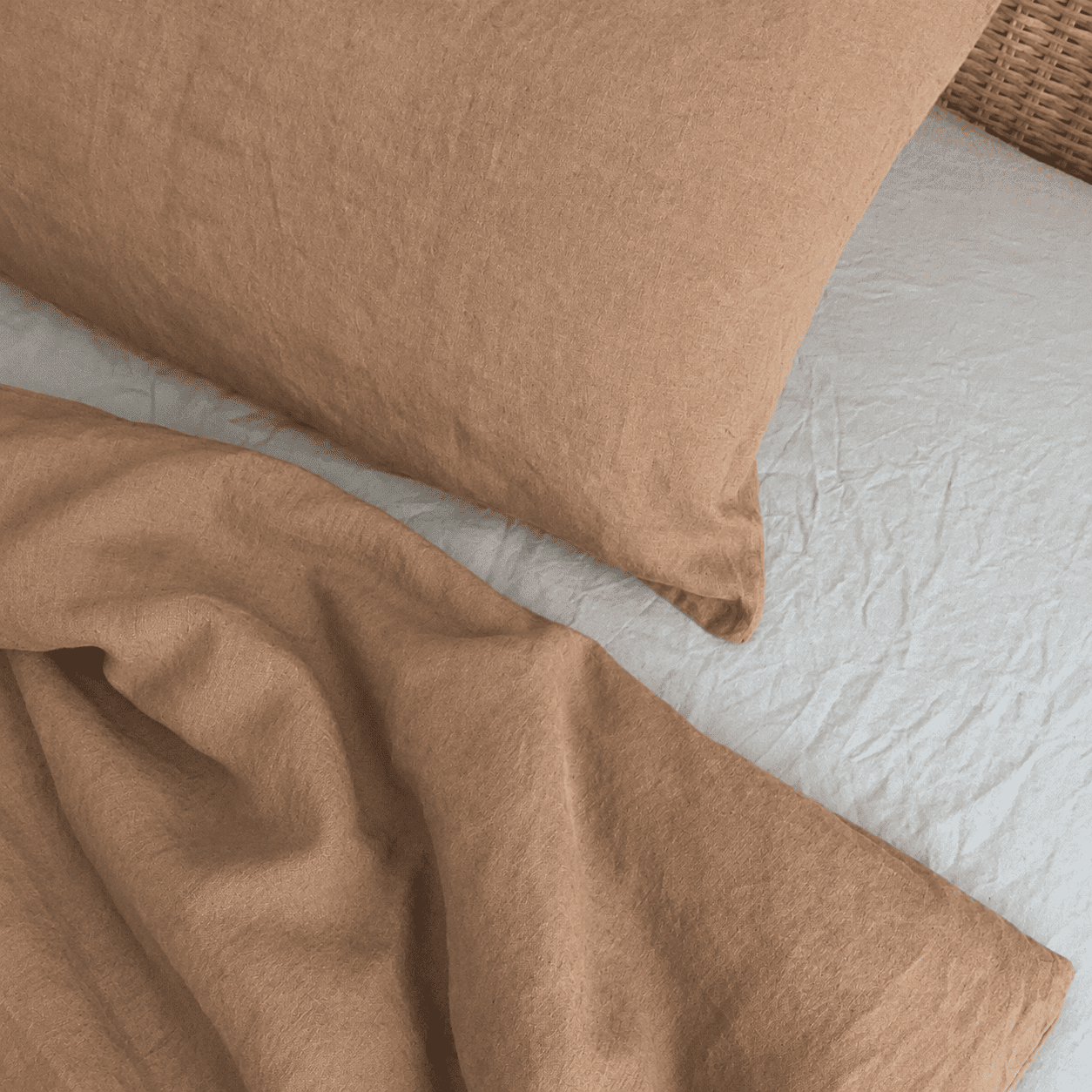 Nahaufnahme Kissen und Bettdeckenbezug von Leinenbettwäsche in Taupe